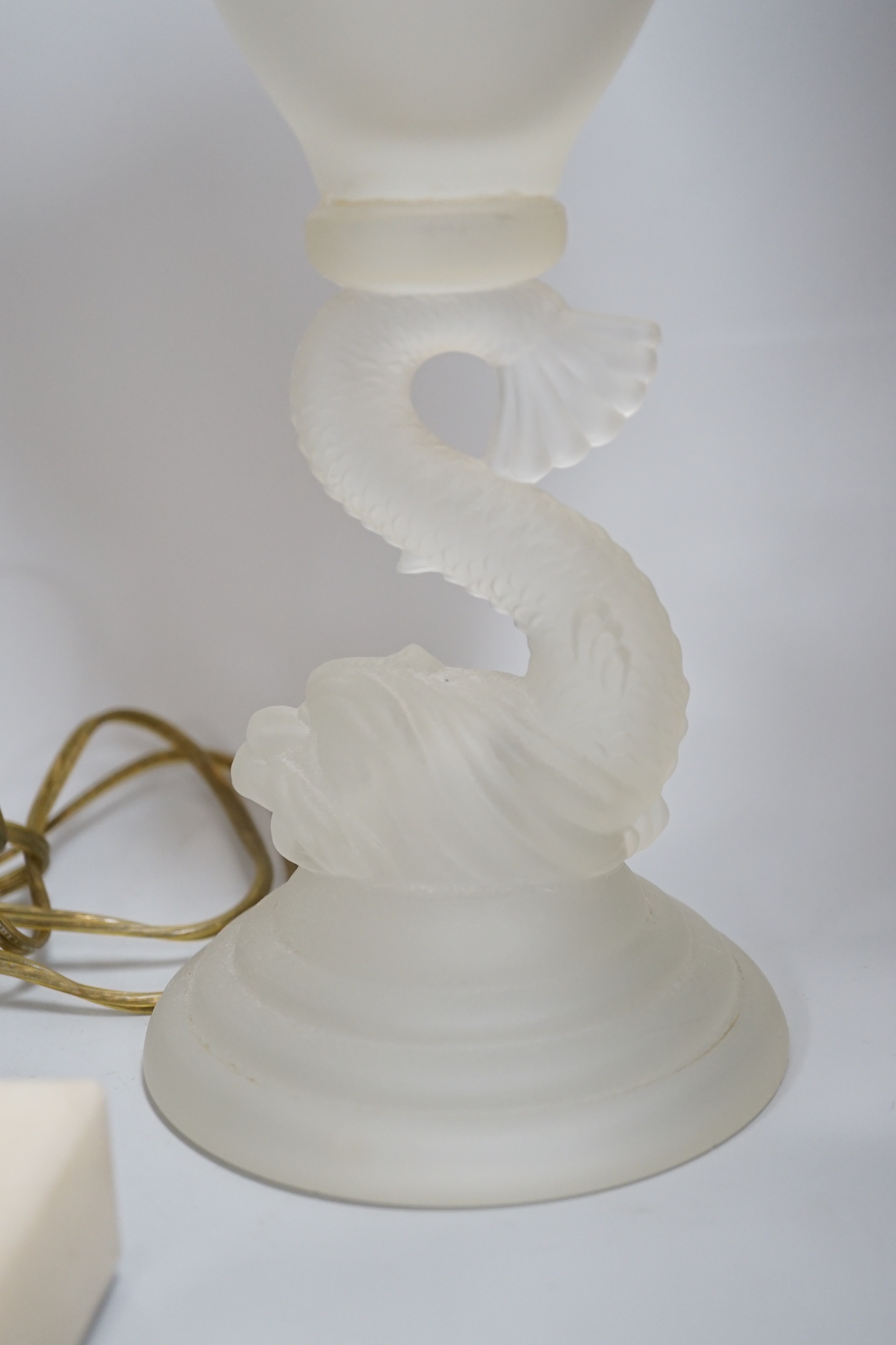 A glass uplighter table lamp in the style of alabaster and two frosted glass dolphin vases